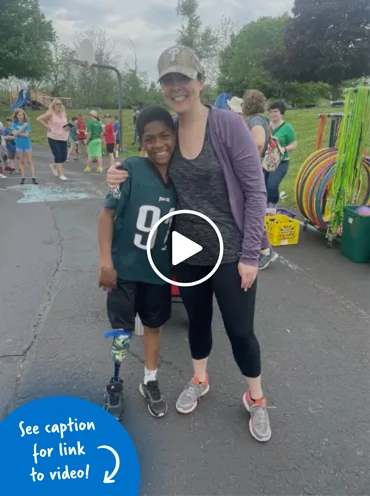 Sudan wearing his prostheticwith an adult enjoying field day