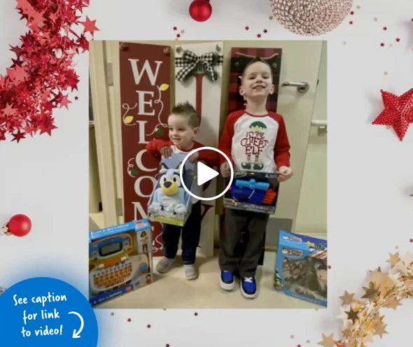 Two young boys holding up the holiday gifts they chose