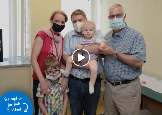 Lara with her family standing with Dr. Standard before her surgery