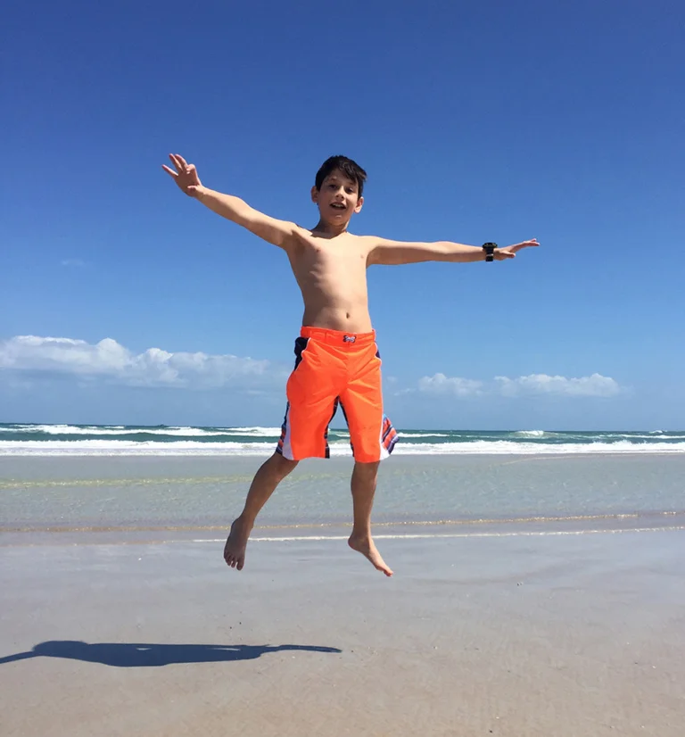 Jackson jumping up high on the beach