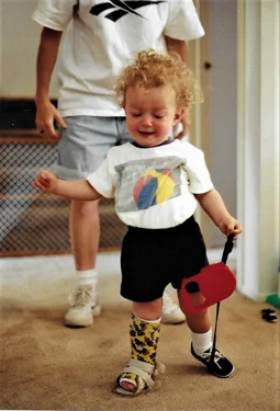 Christopher as toddler walking with cast