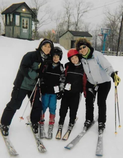 Christopher with his family skiing