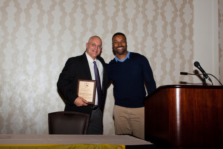 Earl Cole, Survivor: Fiji reality television winner and founder of the Perthes Kids Foundation, presents an award to Dr. Shawn Standard at Rubin Institute for Advanced Orthopedics 2017 Save-A-Limb Fund Dinner
