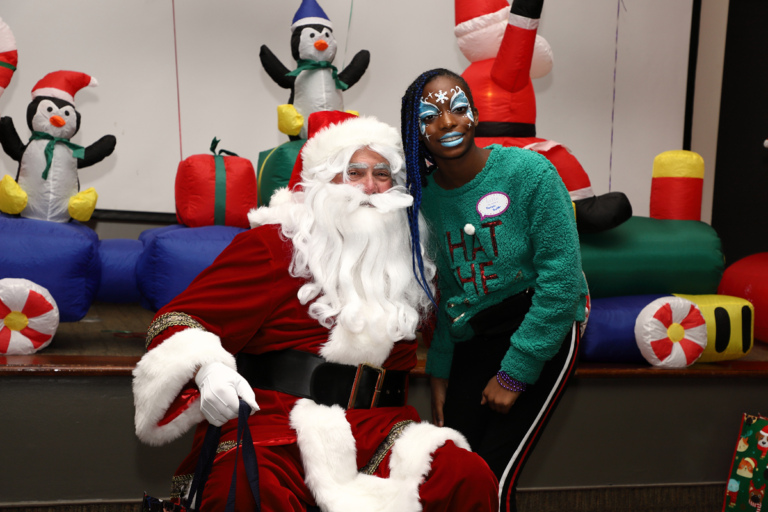 Young woman with face paint smiling with Santa