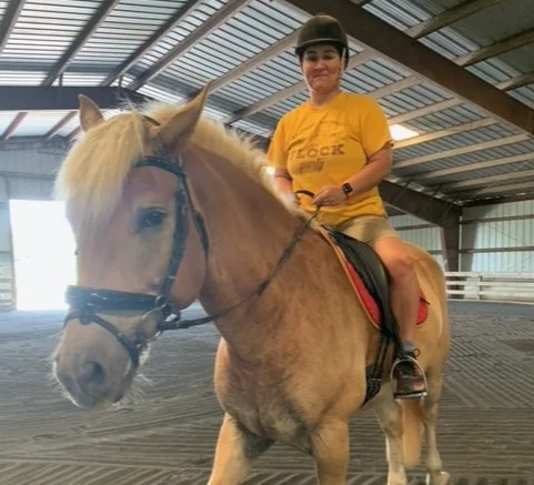 A woman sitting on a horse