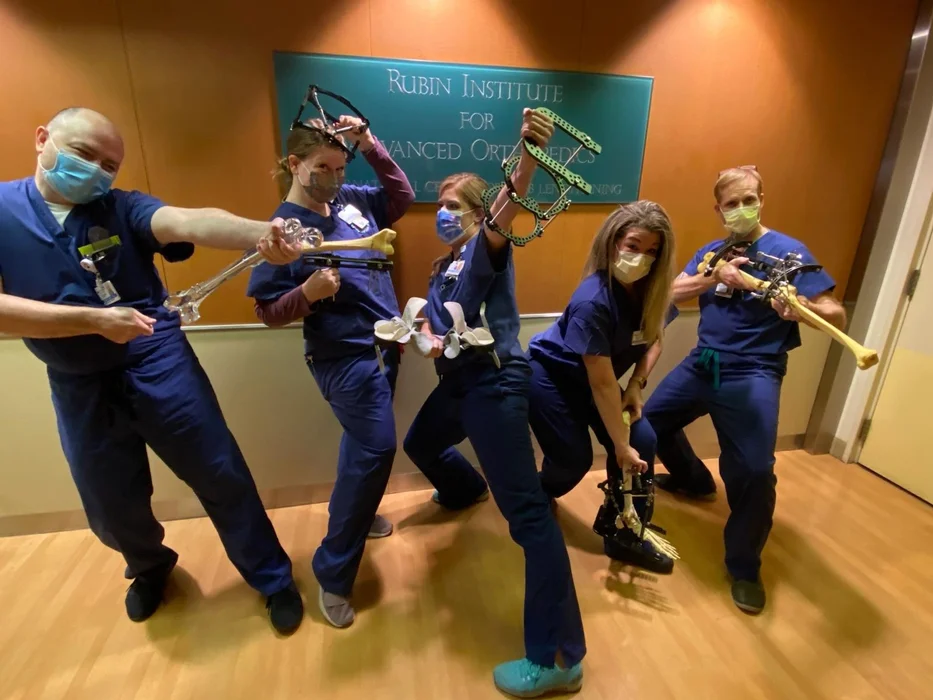 Physician assistants at the International Center for Limb Lengthening posing with bone models and external fixators.