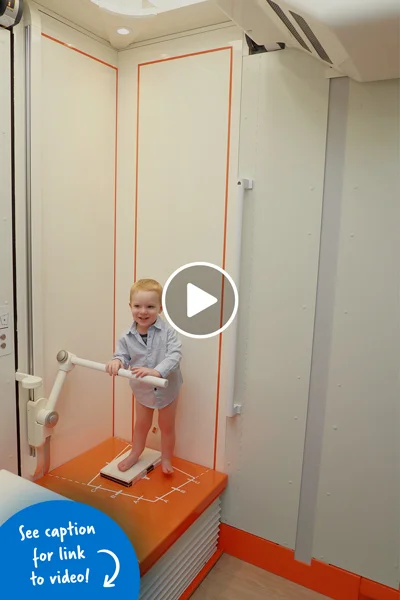 A little boy standing inside an EOSedge machine