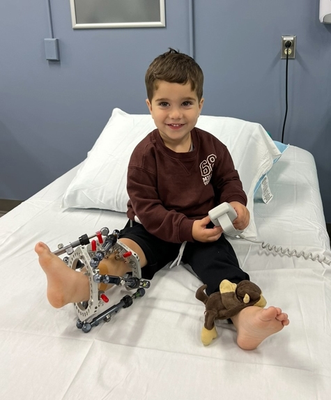 Joey in hospital bed with external fixator on his leg