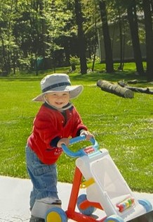 Josh as a toddler with a large shoe lift playing