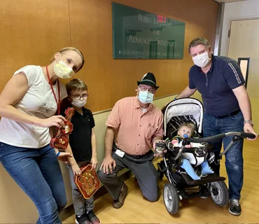 Lara and Family with Dr. Standard wearing an Austrian hat they gave