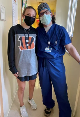 Lexie standing with Dr. McClure in the clinic after a follow-up appointment