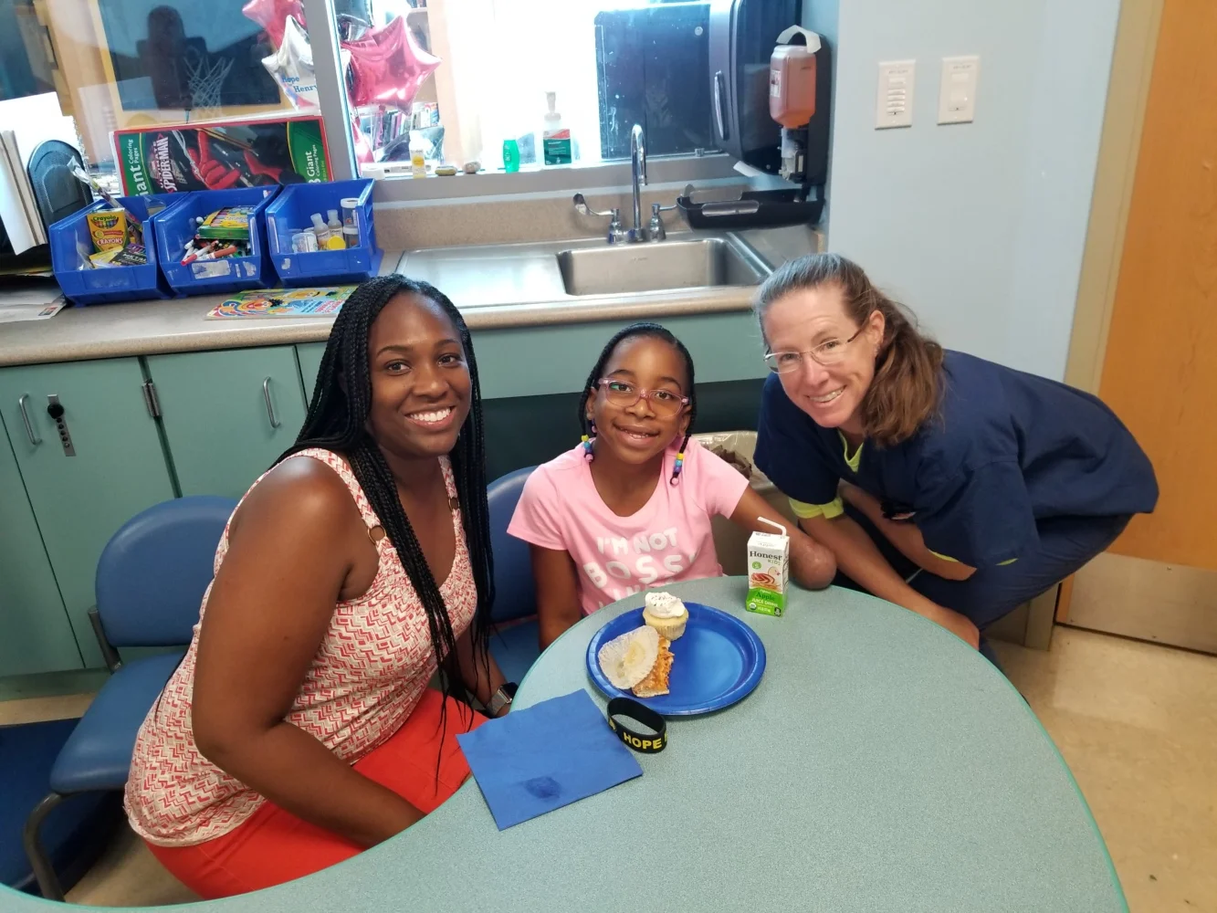 Kennedee enjoying a cupcake with her mom, Kimberlee and Dr. Conway